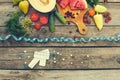 Fruits, vegetables, measure tape, pills on wooden background. Concept of different ways to lose weight.