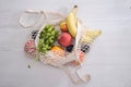 fruits in mesh bag on wooden background copy space top view, eco friendly life style concept, wicker zero waste Royalty Free Stock Photo