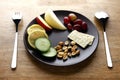 Fruits, vegetables, nuts and crackers on a plate Royalty Free Stock Photo