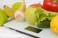 Fruits and vegetables are placed on white electronic scales Royalty Free Stock Photo