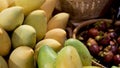 Fruits and vegetables on rustic stall. Assorted fresh ripe fruits and vegetables placed on rustic oriental stall in market. Green