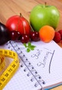 Fruits, vegetables and tape measure with notebook, concept of slimming and healthy food Royalty Free Stock Photo