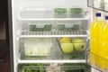 Fruits and vegetables in two containers in a modern fridge