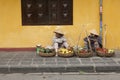 Fruits vendors selling agricultural products on a street of Hoi An ancient town Royalty Free Stock Photo