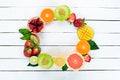 Fruits on a white wooden background. Mango, melon, pomegranate, strawberry, banana. Top view. Royalty Free Stock Photo