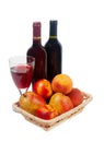 Fruits, wine bottles and a wine glass on a white background Royalty Free Stock Photo