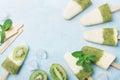 Fruity homemade ice cream or popsicles from kiwi smoothie and yogurt top view. Summer refreshing food. Royalty Free Stock Photo