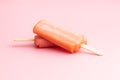 Fruity ice lolly. Sweet popsicle on pink table