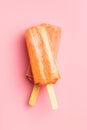 Fruity ice lolly. Sweet popsicle on pink table