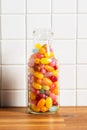 Fruity jellybeans. Tasty colorful jelly beans in glass bottle