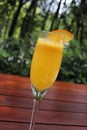 A fruity mimosa champagne cocktail in an outside restaurant Royalty Free Stock Photo