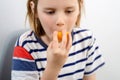 Fruity munch: A young boy munches on a ripe yellow plum, enjoying the fruity goodness in every bite