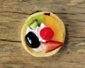 Fruity tart on old wooden floor.