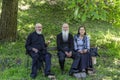 Orthodox monks and parishioner woman in the park of Velika Remeta Monastery in Fruska Gora, Serbia. Royalty Free Stock Photo