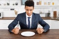 Frustrated african american man holding cutlery Royalty Free Stock Photo