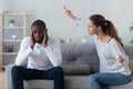 Frustrated african american man tired from quarreling shouting wife.