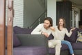 Frustrated angry young man sitting on couch ignoring arguing wif Royalty Free Stock Photo