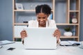 Frustrated, angry and stressed young business woman on a laptop in a modern office. Female showing anger with technology Royalty Free Stock Photo