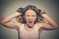 Frustrated angry woman pulling hair out yelling screaming Royalty Free Stock Photo