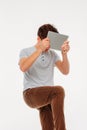 Frustrated, angry young man, student trying to break up the tablet on knee