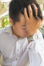 Frustrated Asian married man having headache and feel tired
