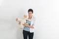 Frustrated attractive young woman biting a plush toy or teddy bear with a snarl and frown of anger Royalty Free Stock Photo