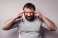 Frustrated bearded man touching his head with hands and keeping eyes closed Royalty Free Stock Photo