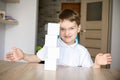 Frustrated boy destroying brick tower he built. Royalty Free Stock Photo