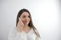 Frustrated brunette hispanic young woman talking by phone with husband, in troubles. Pretty caucasian girl at home using Royalty Free Stock Photo