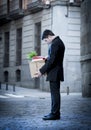 Frustrated business man on street fired carrying cardboard box Royalty Free Stock Photo