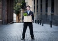 Frustrated business man on street fired carrying cardboard box Royalty Free Stock Photo