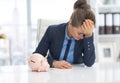 Frustrated business woman with piggy bank Royalty Free Stock Photo