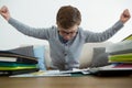 Frustrated businessman with arms outstretched sitting on sofa