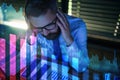 Frustrated businessman with computer sitting at desk, financial crisis and corona virus concept. Royalty Free Stock Photo