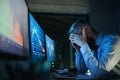 Frustrated businessman with computer sitting at desk, working late. Financial crisis concept. Royalty Free Stock Photo