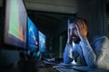 Frustrated businessman with computer sitting at desk, working late. Financial crisis concept. Royalty Free Stock Photo