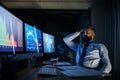 Frustrated businessman with computer sitting at desk, working late. Financial crisis concept. Royalty Free Stock Photo