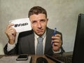 Frustrated businessman desperate at office computer desk holding notepad with the hashtag me too metoo as exploited employee Royalty Free Stock Photo