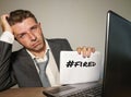 Frustrated businessman desperate at office computer desk holding notepad with the hashtag me too metoo as exploited employee Royalty Free Stock Photo