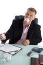 Frustrated businessman with paper in his mouth Royalty Free Stock Photo