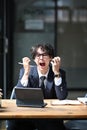 Frustrated business man screaming while sitting at office desk. Royalty Free Stock Photo
