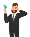 Frustrated businessman showing credit, debit, ATM card. Unhappy stressed man holding hand on head. Male character design.