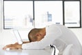 Frustrated Businessman Sitting At Desk In Office Using Laptop Royalty Free Stock Photo