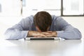 Frustrated Businessman Sitting At Desk In Office Using Laptop Royalty Free Stock Photo