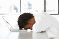 Frustrated Businessman Sitting At Desk In Office Using Laptop Royalty Free Stock Photo