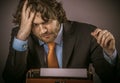 Frustrated Businessman Staring at his Typewriter