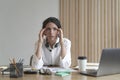 Frustrated businesswoman feeling tired while sitting in office, suffering from headache at work Royalty Free Stock Photo