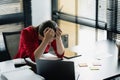 Frustrated businesswoman holding her head, tired from work, having problem with project, suffering from headache Royalty Free Stock Photo