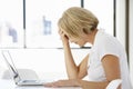 Frustrated Businesswoman Sitting At Desk In Office Using Laptop Royalty Free Stock Photo