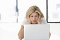 Frustrated Businesswoman Sitting At Desk In Office Using Laptop Royalty Free Stock Photo